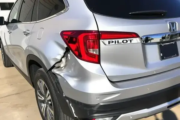SUV with significant rear-end collision damage requiring extensive bodywork